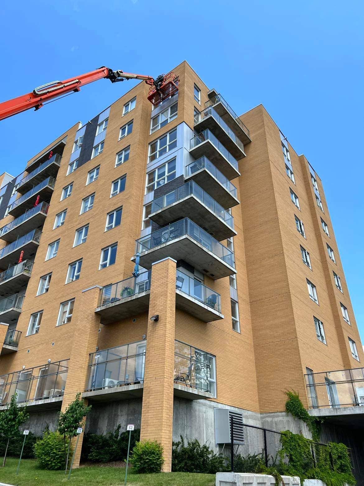 JLG boom lift deployed along a glass tower downtown